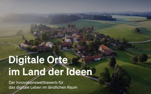 Luftaufnahme von Dorf inmitten grüner Wiesen