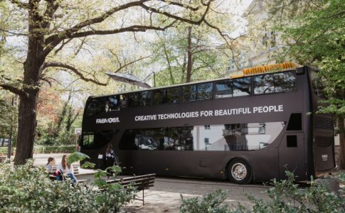 schwarzer Bus umgeben von Bäumen und Büschen